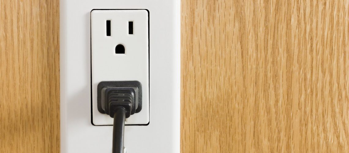 Electrical-outlet-with-black-p